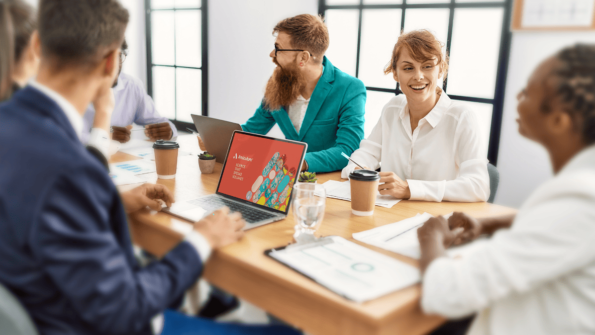 Group of people sat around a table having a productive discussion