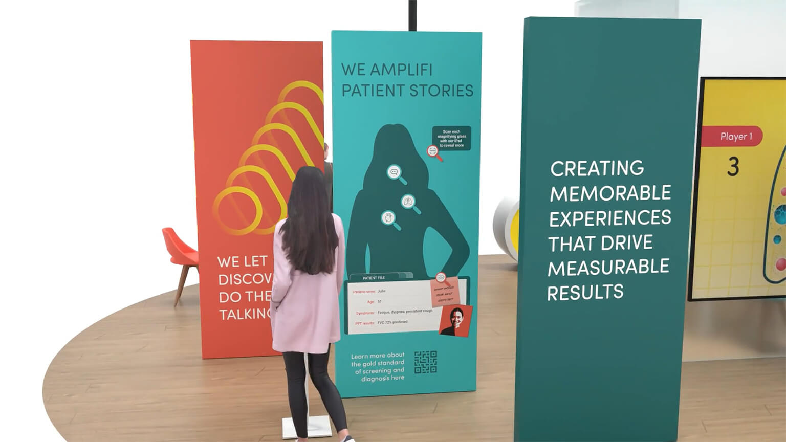 A person walking past a series of poster panels in aqua and coral saying 'creating memorable experiences that drive measurable results and 'we Amplifi patient stories'